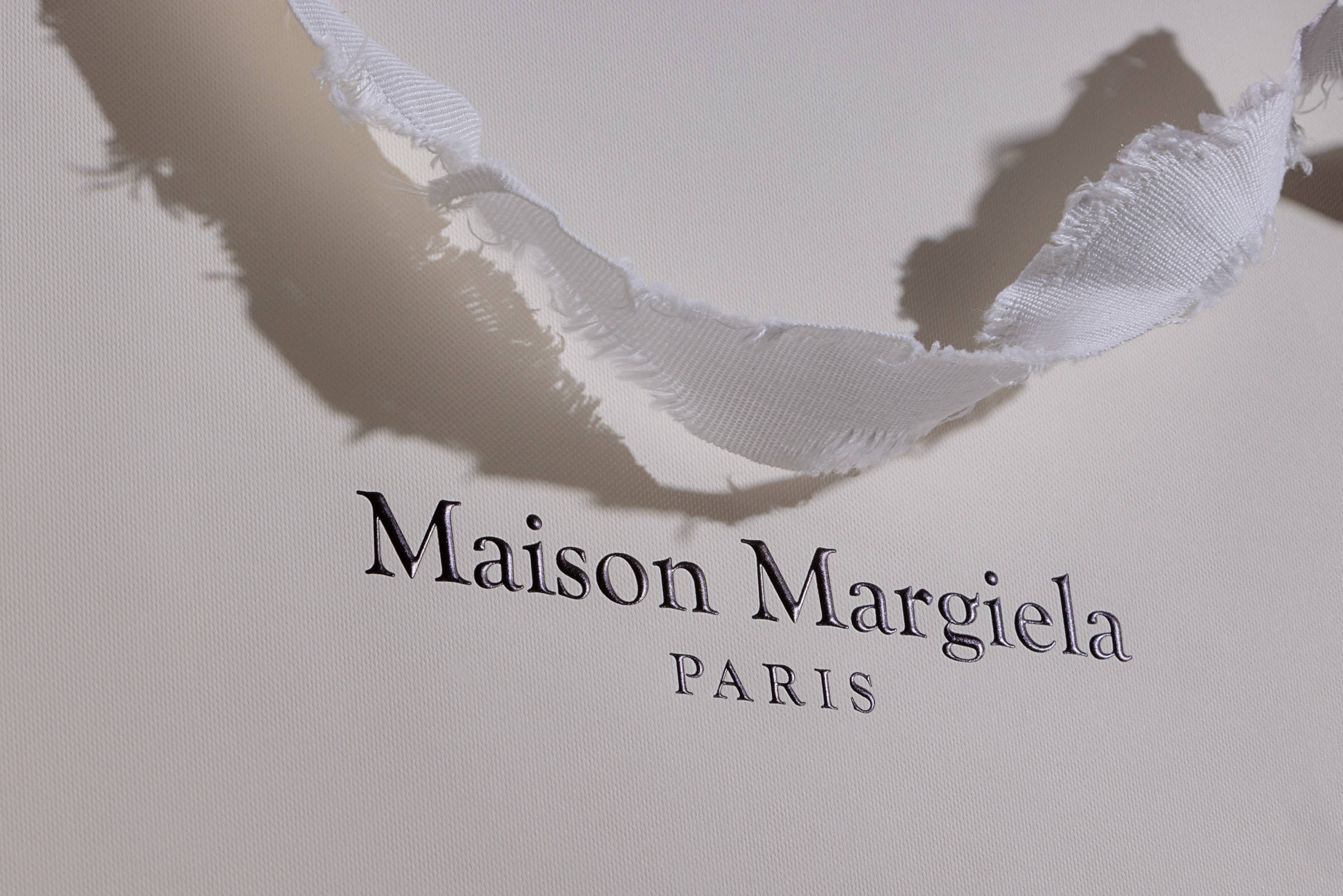 Luxury retail packaging Maison Margiela torn handles Recyclable Packaging Idpdirect.com sustainable Manufacturing